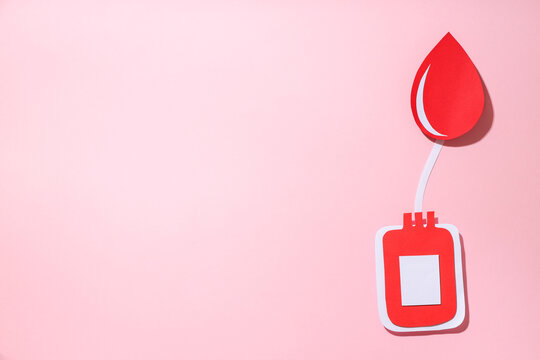 Red paper blood drop and container design on pink background