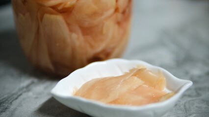Pickled ginger in a glass jar. Selective focus. Close up.