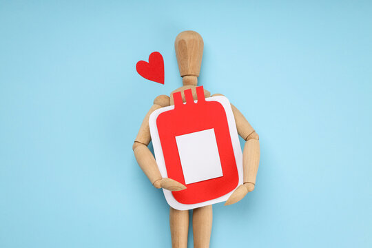Wooden figure embraces large red representation of blood donation
