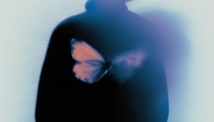 A blurred butterfly silhouette in vibrant pinks against a dreamy blue backdrop, creating a surreal, ethereal visual effect.