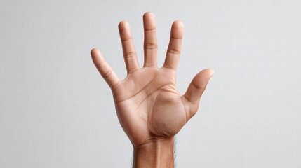 Hand displaying five fingers against a plain background.