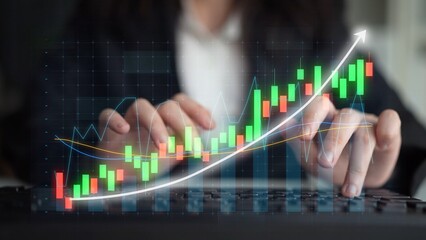 A business professional focuses on stock chart analysis with vibrant color data visualization. The image showcases finance trends and growth in a modern office setting. Copula