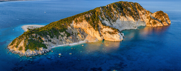 Aerial view of the island of Marathonisi or Turtle island and beach in the bay of Laganas during summer sunset time, Zakynthos, Greece