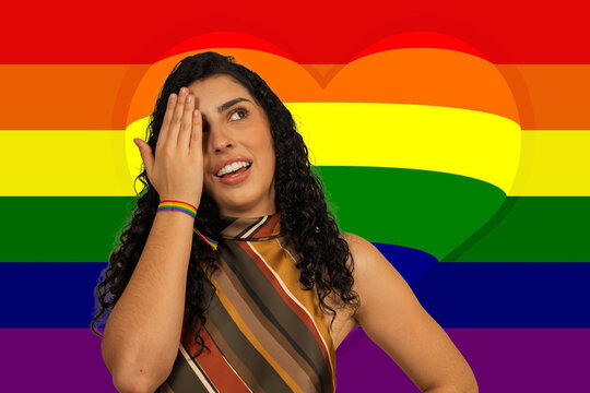 Woman celebrating lgbtq+ pride with a rainbow flag background