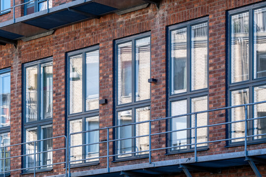Urban architecture reflected across a glass facade where crossing lines and geometric forms interact with vivid color and soft light for modern detail