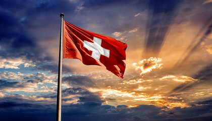 Flag of Switzerland Waving on a Pole Against a Dramatic Sunset Sky Background
