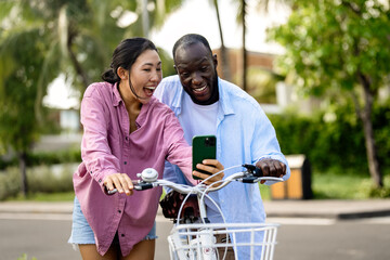 Interracial couple embracing technology, diverse couple enjoying vacation travel relaxation