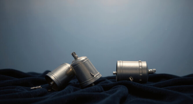 Intriguing metal parts resting on soft fabric, perfect for industrial design concepts, engineering projects, or artistic explorations of mechanics and form