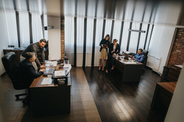 A team of business professionals engaging in collaborative work within a contemporary office environment.