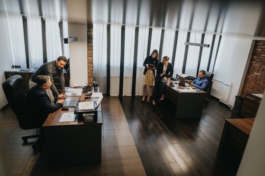 A team of business professionals engaging in collaborative work within a contemporary office environment.