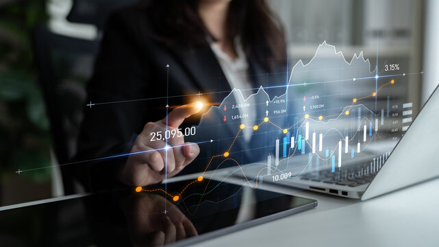 A businesswoman analyzes stock market trends using graphs and data visualization on her laptop in a modern office setting. Focus on financial metrics and technology integration. Scalp
