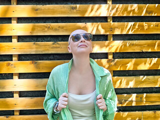 Bald girl smiling confidently after overcoming cancer, embracing life in recovery