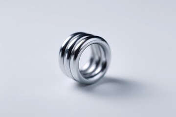 Metallic spring with three grooves isolated on a smooth background for clarity