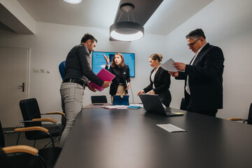 Group of business professionals engaged in a collaborative team meeting in a modern office setting, discussing projects and sharing ideas to achieve optimal outcomes.