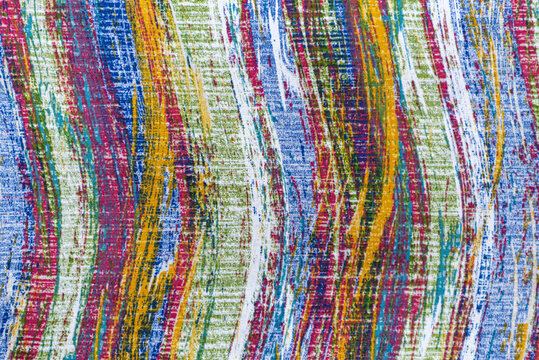 Abstract background with wavy brushstroke pattern painted on canvas texture.