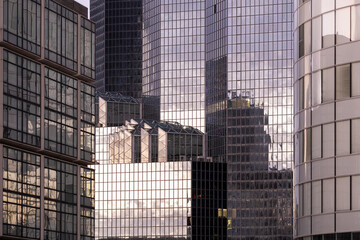 Architecture and skyscrapers shaping reflection and contrast on glass across a broad cityscape linked to finance in the urban landscape of the financial district in La Defense in Paris