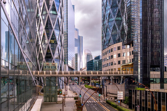 Skyscrapers and architecture shaping a cityscape of finance with reflection on glass and contrast across the urban landscape of the financial district in La Defense in Paris