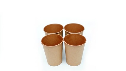 4 brown paper parchment coffee cups on white background