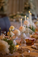 Elegant wedding table decoration with candles and white flowers