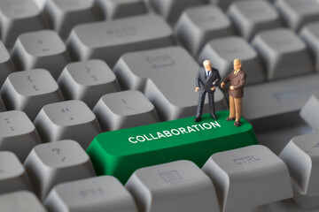 Miniature Business Figures Standing on Keyboard Button with Text Collaboration. Representing teamwork, partnership, communication, and cooperative business processes.