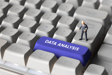 Miniature Businessman Standing on Keyboard Button with Text Data Analysis. Representing analytics, data processing, business intelligence and digital transformation