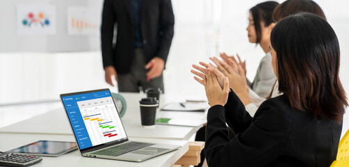 Project planning software for modish business project management on the computer screen showing timeline chart of the team project