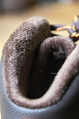 Close view of a warm shoe lining with soft fleece interior, highlighting comfort, insulation, and cozy winter footwear design.