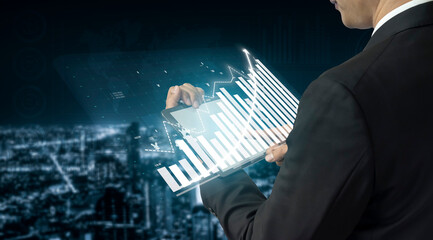 A business professional engages with digital financial data on a touchscreen in a modern office, illustrating growth trends, strategic insights, and innovation. Impute