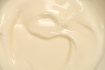 An extreme close-up captured from a top-down perspective shows the smooth, creamy texture of white chocolate pudding