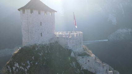A breathtaking drone orbit video of a historic hilltop fortress with a panoramic city view unfolding at its base. Ideal for travel films, historical documentaries, or city promotion projects.
