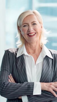 Mature woman, face and arms crossed at office with pride, happy or actuary career at insurance company. Person, smile and consultant in portrait, job or confident at risk management agency in Germany