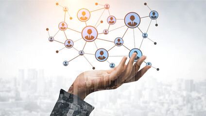 A hand reaches out toward a stylized digital network representing users and connections, symbolizing social interactions and community in a modern city. Tessel