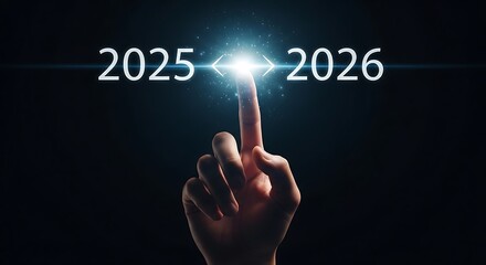 Finger points to the future from 2025 to 2026 with bright light