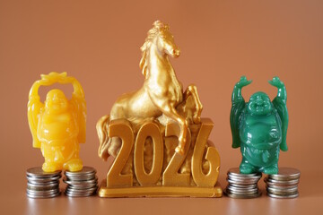 A horse figurine with the number 2026 and small Buddha figurines with coins.