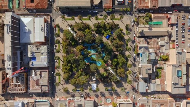 Bird's-eye view of the Plaza de Armas and the central fountain on a sunny day in the city of Ovalle in the Limar&iacute; Valley, low traffic on a weekday, northern Chile.
