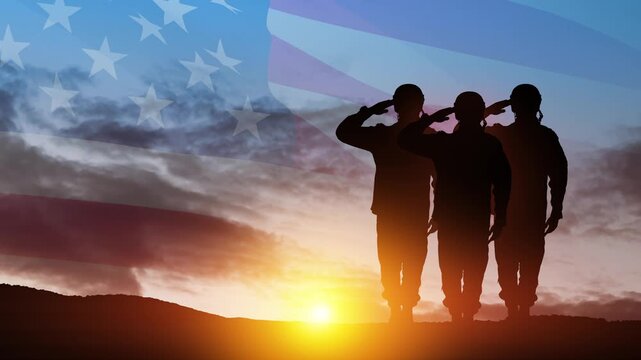 Silhouettes of soldiers saluting on background of sunset or sunrise and USA flag. Veterans Day, Memorial Day, Independence Day. America celebration.
