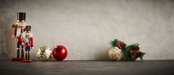 A festive Christmas scene featuring classic wooden nutcracker figurines, decorative ornaments, and a blank greeting card on a textured background, perfect for holiday promotions.
