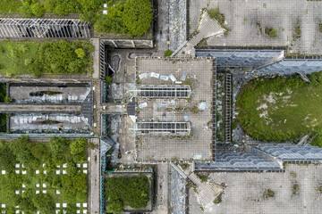 Aerial view of a concrete structure overtaken by vibrant greenery, where nature reclaims the stark architectural lines, Zagreb, Croatia.