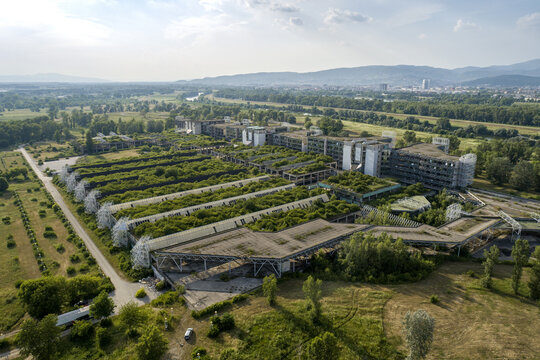 Aerial view of the skeletal remains of a once-grand building, now overtaken by vibrant greenery, stand as a testament to time's passage, Zagreb, Croatia.