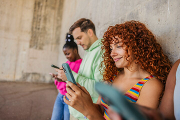 Young diverse people connecting with mobile phones