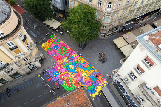Naklejki Aerial view of a vibrant, colorful street art installation at the intersection of historic buildings, a burst of modern creativity amidst classic European architecture, Zagreb, Croatia.