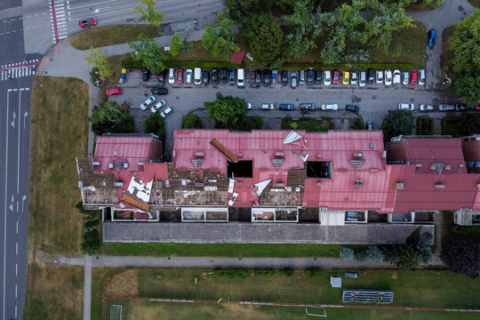 Aerial view of damaged rooftops reveal a stark contrast against the orderly rows of parked cars in the background, Zagreb, Croatia.
