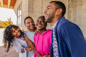Diverse young adult friends laughing together and having fun