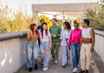 Diverse group of friends walking together talking outdoors