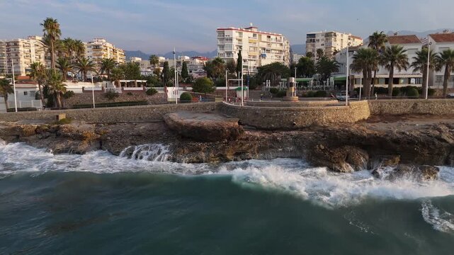Aerial Drone POV of Nerja coastal town, which is a municipality on the Costa del Sol in the province of Malaga in the autonomous community of Andalusia in southern Spain.