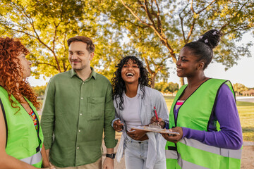 Diverse volunteer group interviewing people for a community survey