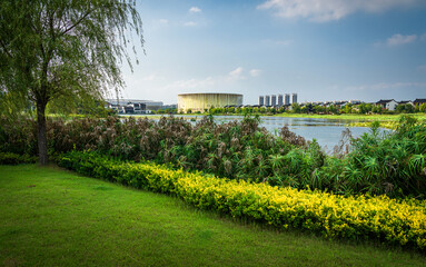 Serene Riverside Landscape Featuring Vibrant Flora and Modern Infrastructure