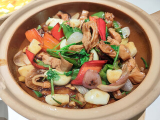 Colorful Chicken Stew with Fresh Vegetables in a Rustic Clay Pot