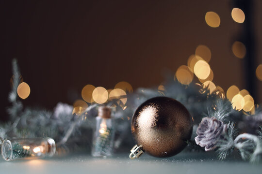 Christmas ball on brown background with bokeh lights
