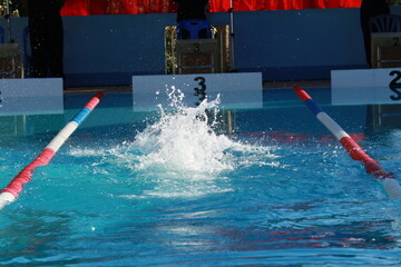 Swimming competition in the pool, close-up of water splashes